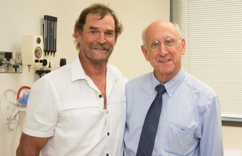 Rosenberg with a patient Rosenberg poses with smiling male patient